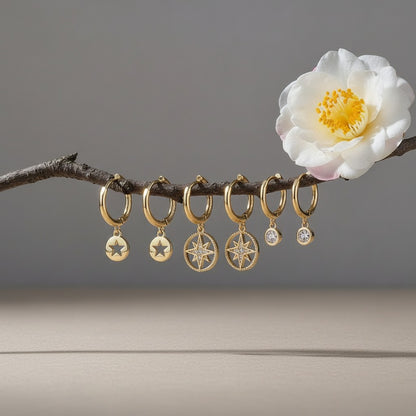 Aramat Jewels set of 3 pairs of gold-plated 925 silver hoop earrings with star and zirkonia charms.