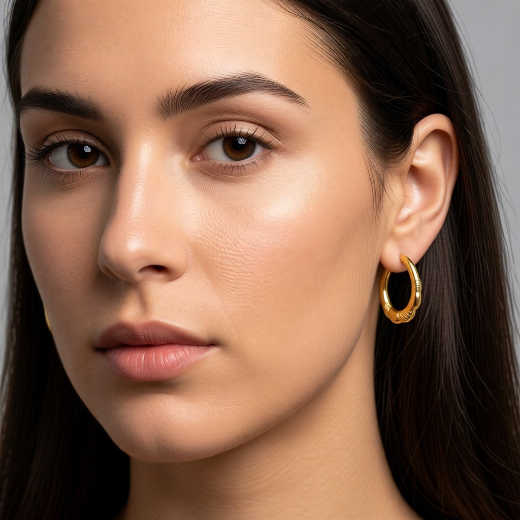 Aramat Jewels gold stainless steel hoop earrings with a striped design, 20mm diameter.