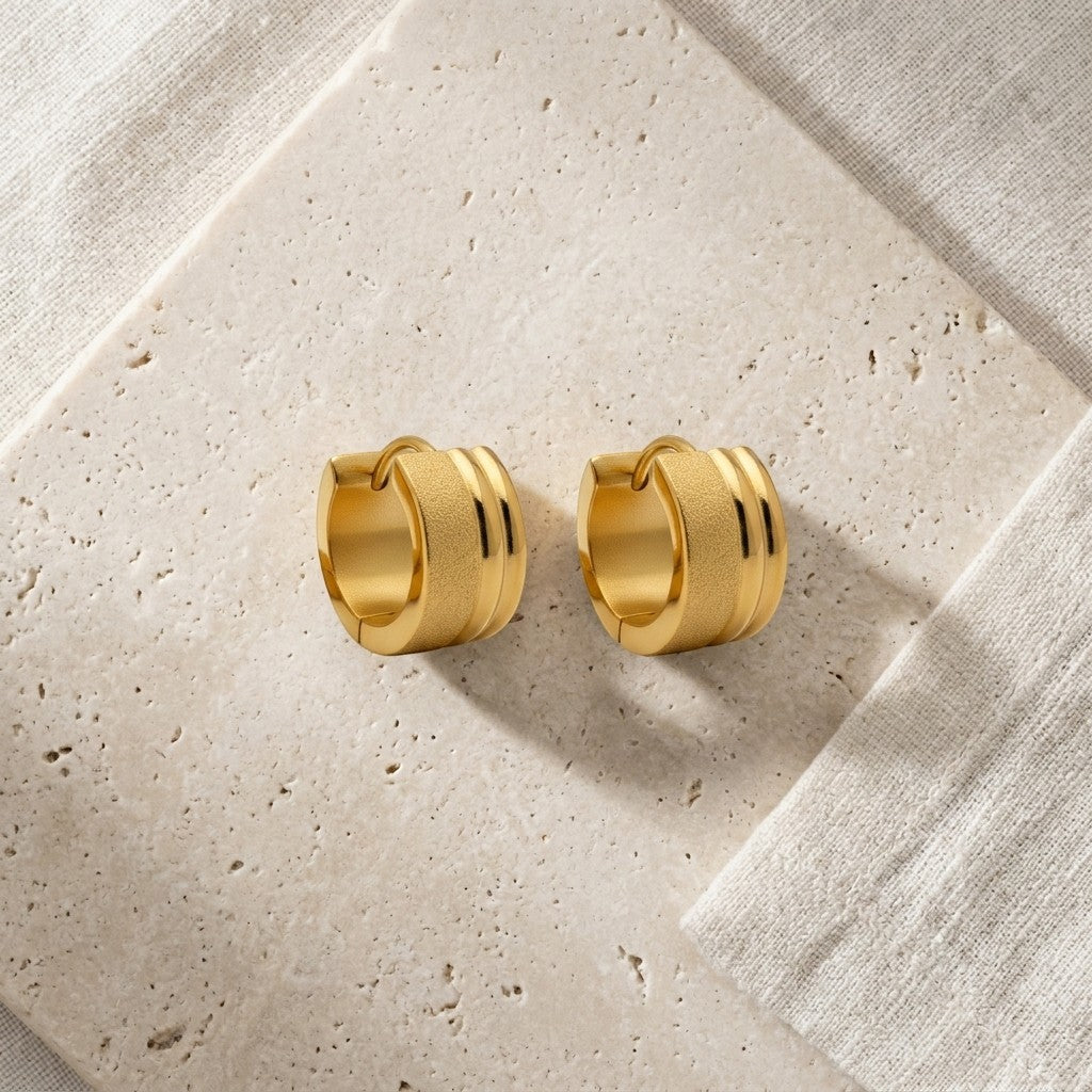 Aramat Jewels gold-tone stainless steel huggie hoop earrings with sandblasted and glossy stripes, 13x7mm.