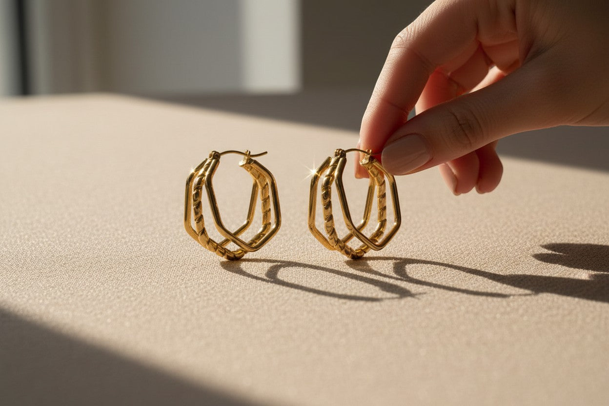 Aramat Jewels gold-tone stainless steel triple hoop earrings with a swirl design, 30x28mm.