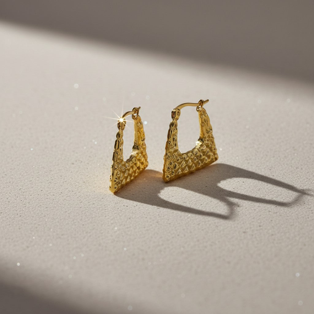 Aramat Jewels gold-tone stainless steel trapeze hoop earrings with a diamond pattern texture, 22mm.