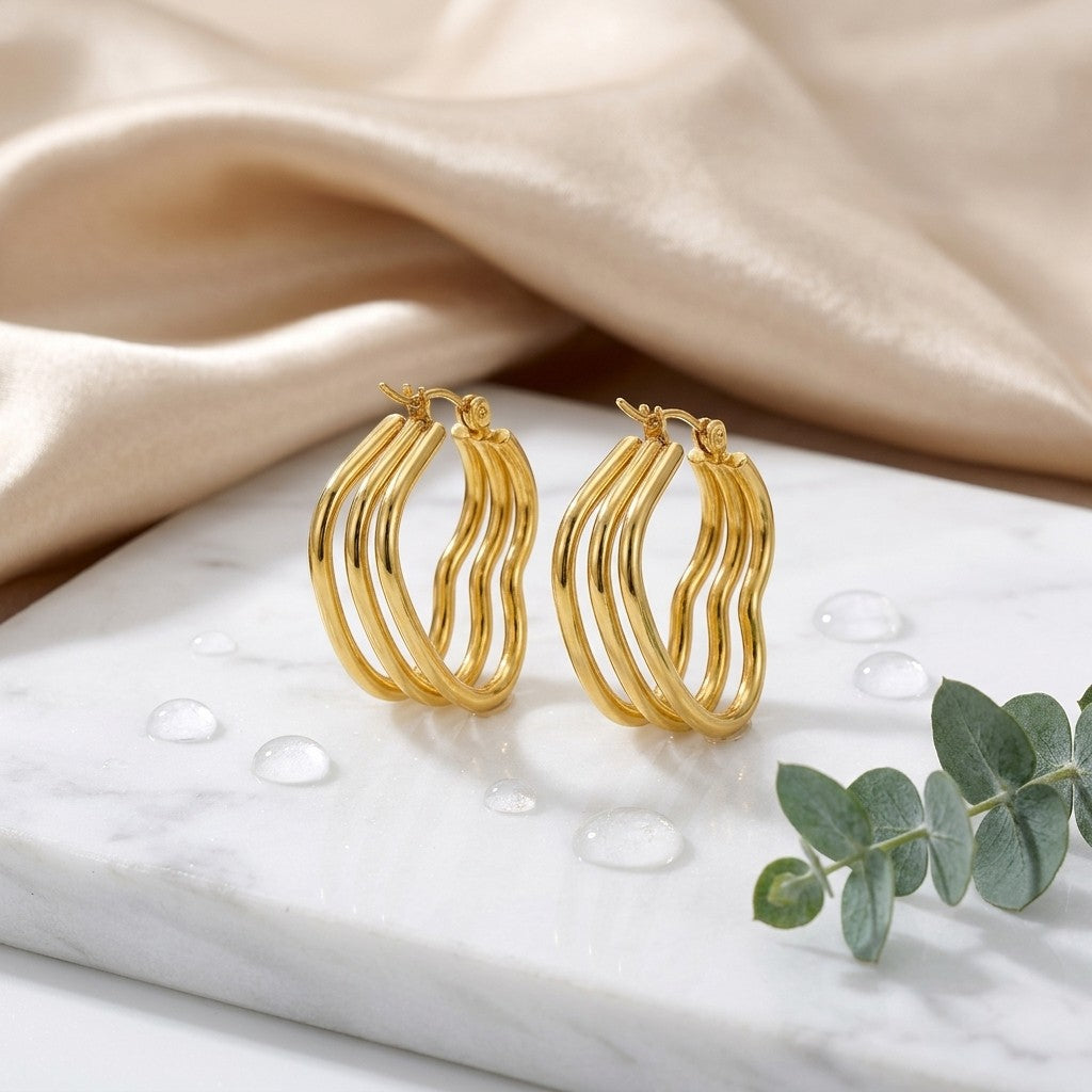Aramat Jewels gold-tone triple heart hoop earrings, made of stainless steel, 25mm high.