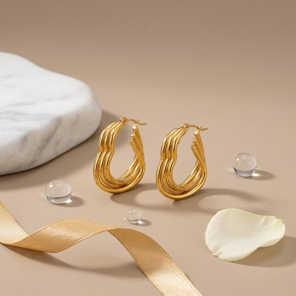 Aramat Jewels gold triple heart hoop earrings, 25mm, made of stainless steel with a smooth finish and hinge closure.