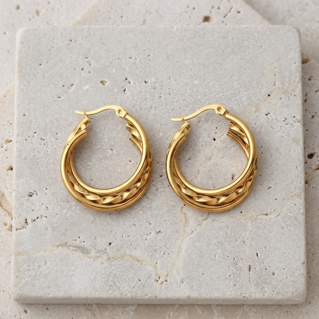 Aramat Jewels gold-tone triple hoop earrings, featuring two smooth rings and one twisted ring, 30x7.5mm.