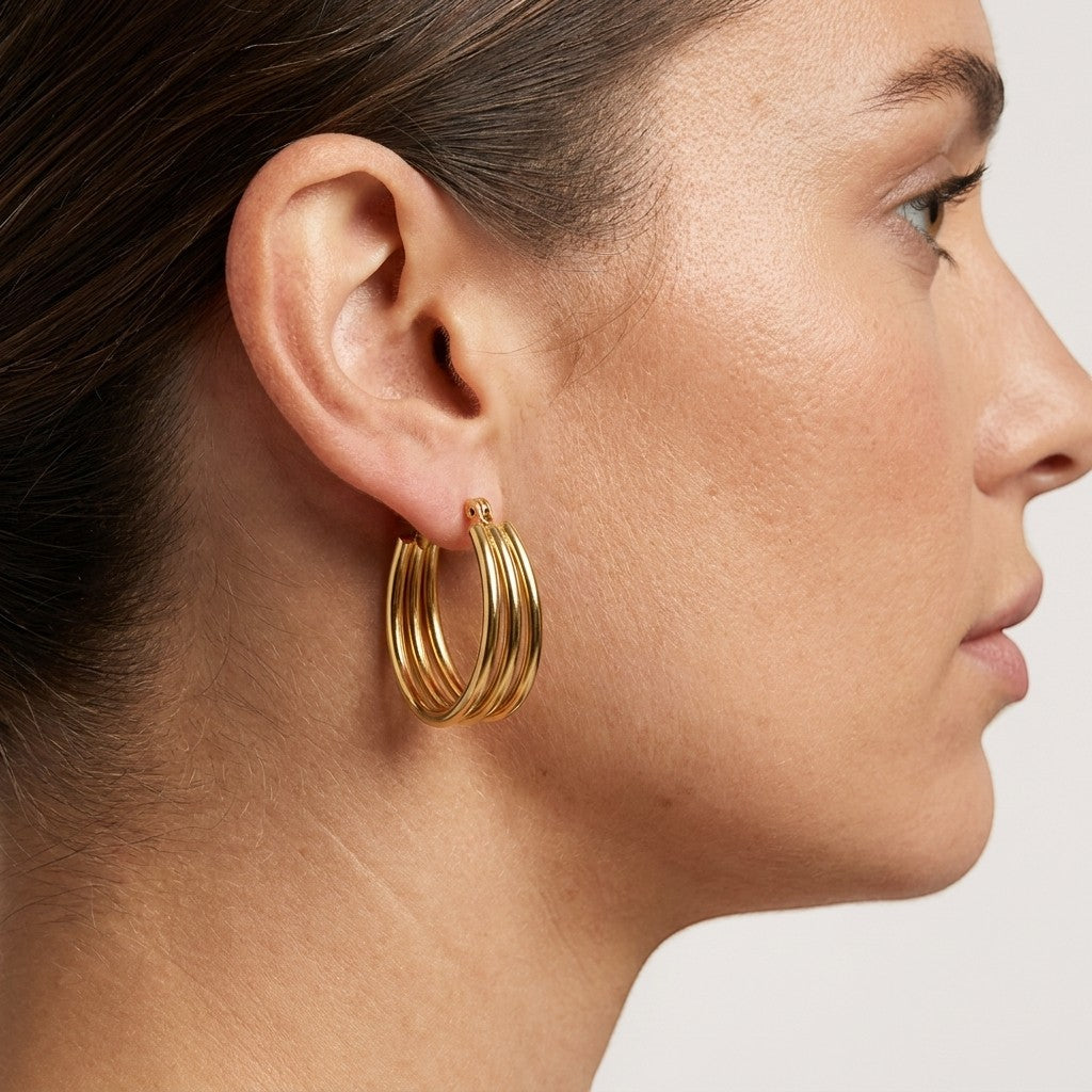 Aramat Jewels gold oval triple hoop earrings, 26x18mm, made of stainless steel with an open design.
