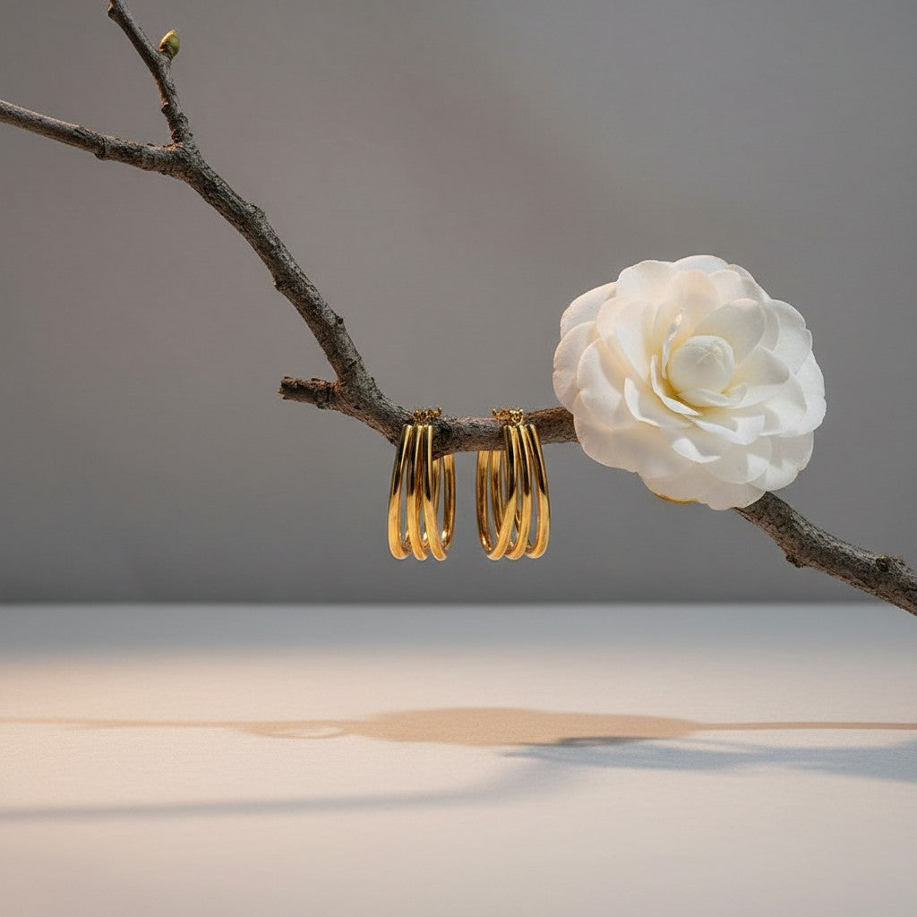 Aramat Jewels gold oval triple hoop earrings, 26x18mm, made of stainless steel with an open design.