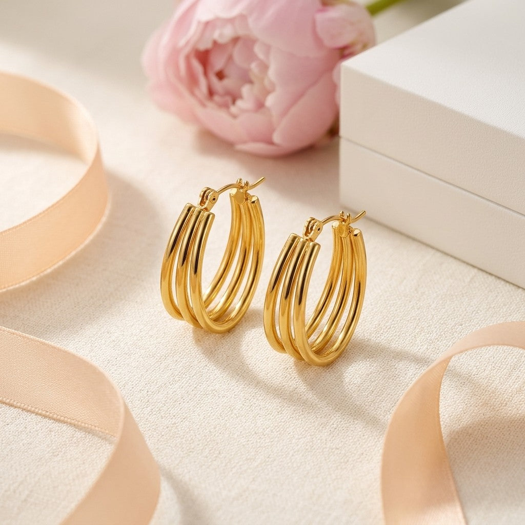 Aramat Jewels gold oval triple hoop earrings, 26x18mm, made of stainless steel with an open design.