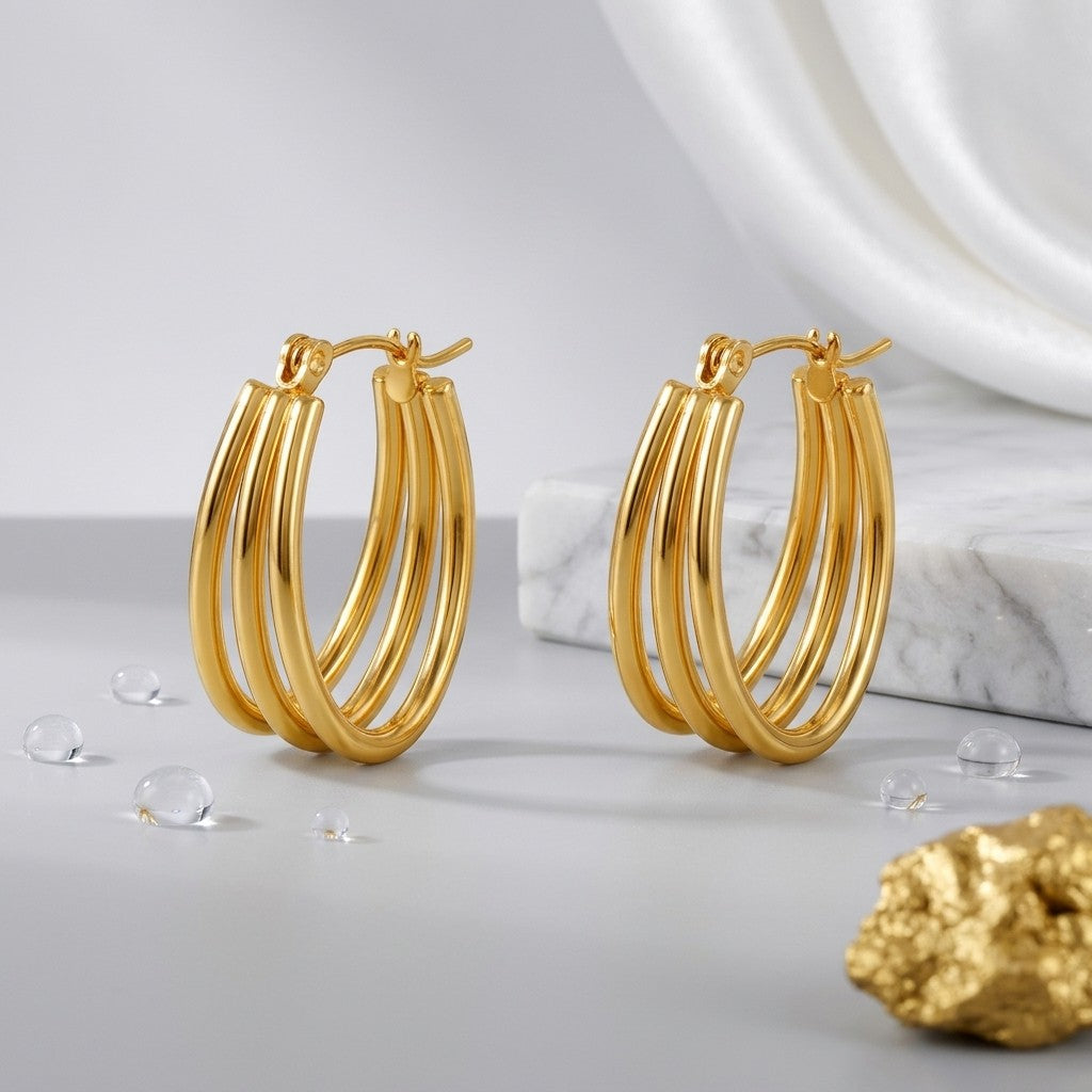 Aramat Jewels gold oval triple hoop earrings, 26x18mm, made of stainless steel with an open design.