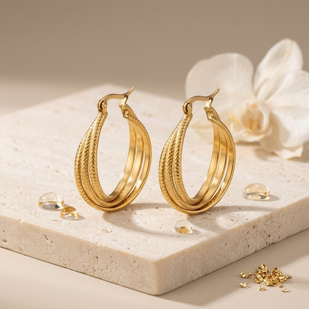 Aramat Jewels gold triple hoop earrings with a textured stripe pattern, 20x7.5mm, made of stainless steel.