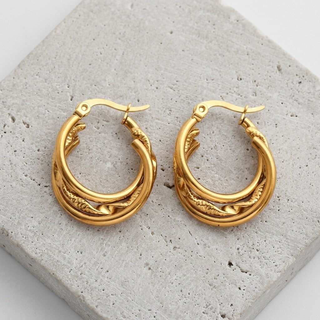 Aramat Jewels gold-tone stainless steel 3-in-1 hoop earrings with twist detail, 20mm diameter.