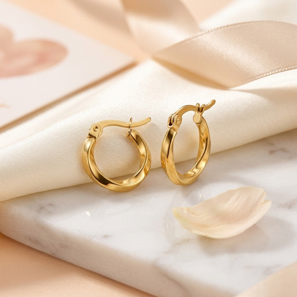 Aramat Jewels gold twisted hoop earrings, 10mm diameter, made of stainless steel with a hinge closure.