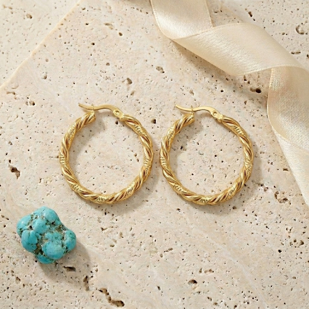Aramat Jewels gold-tone stainless steel twisted hoop earrings, 30mm diameter, elegant and trendy design.