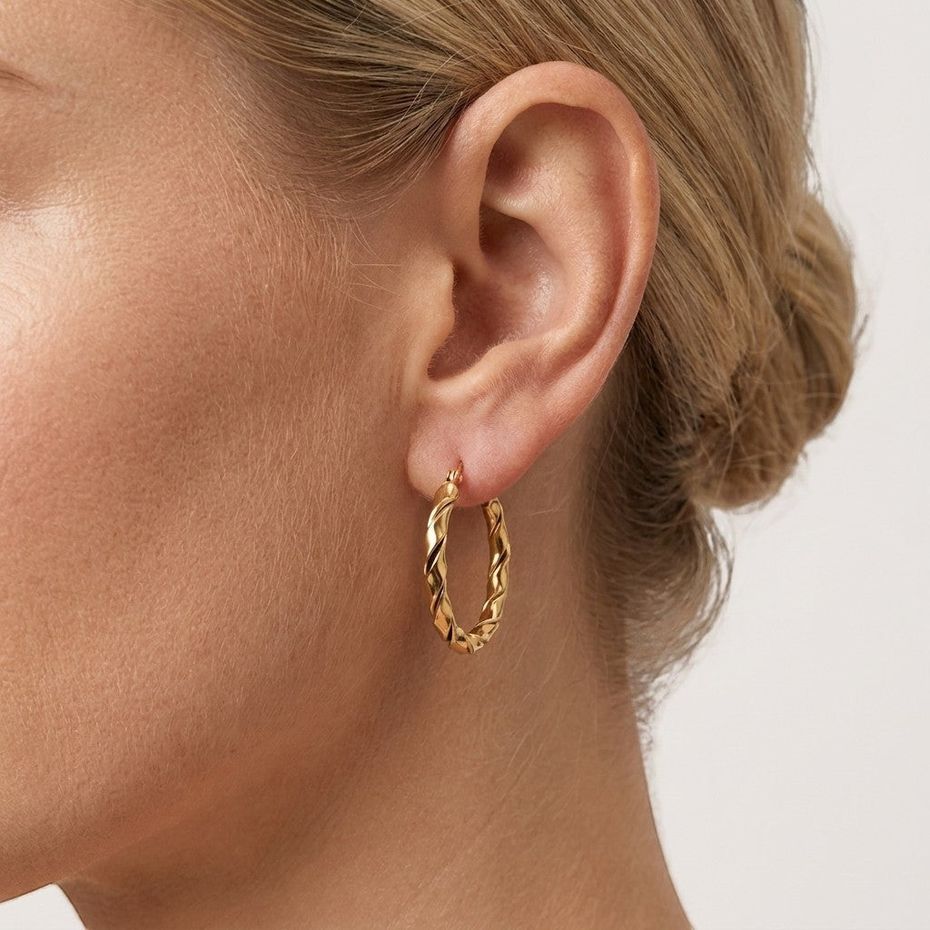 Aramat Jewels gold-tone twisted hoop earrings, 25mm or 45mm, made of stainless steel.