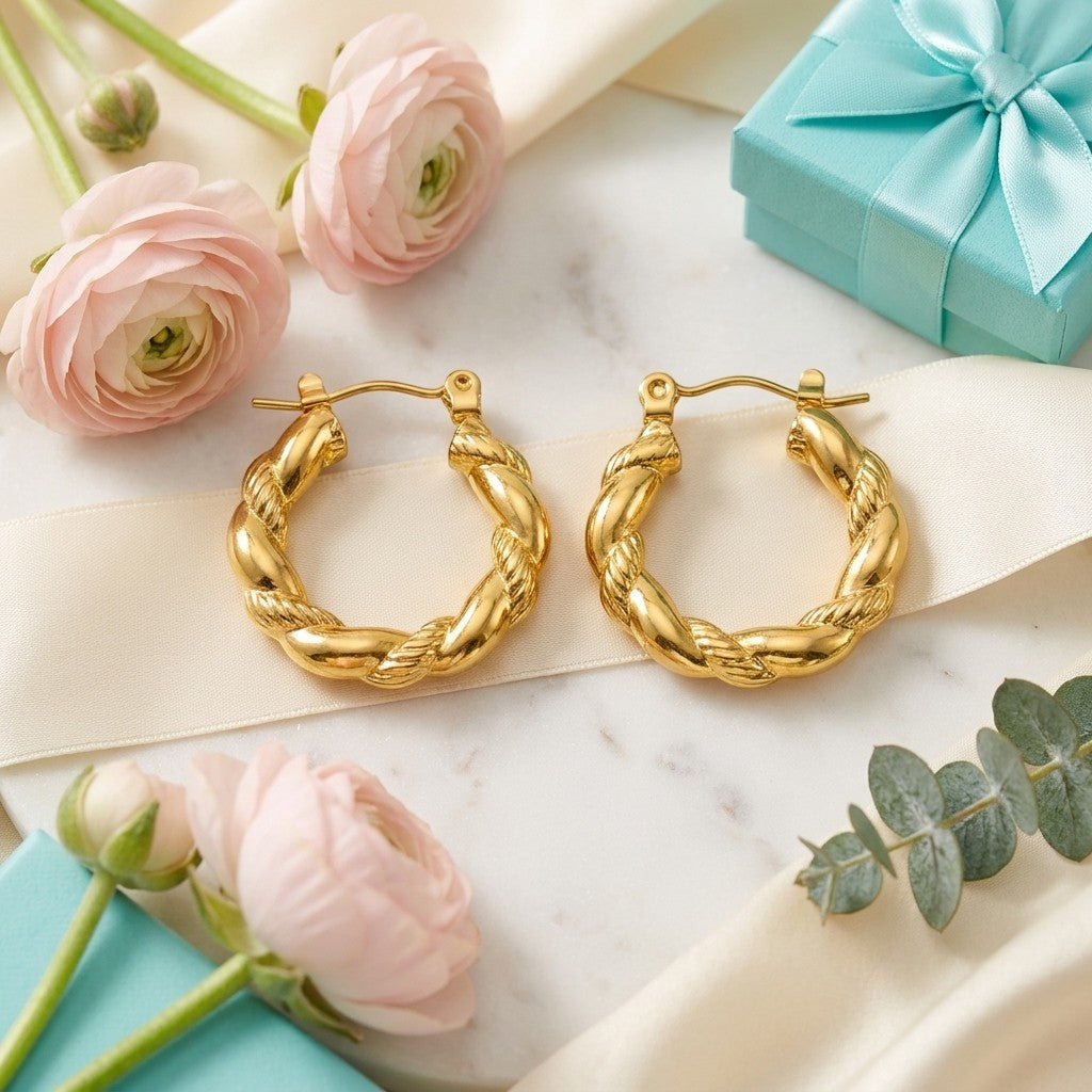 Aramat Jewels gold-colored stainless steel twisted hoop earrings, 22mm diameter, with a unique braided design.