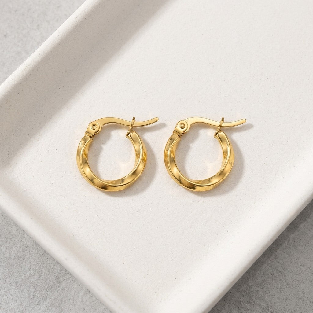 Aramat Jewels gold-tone stainless steel twisted hoop earrings, 10mm diameter, 2mm width, with hinge closure.