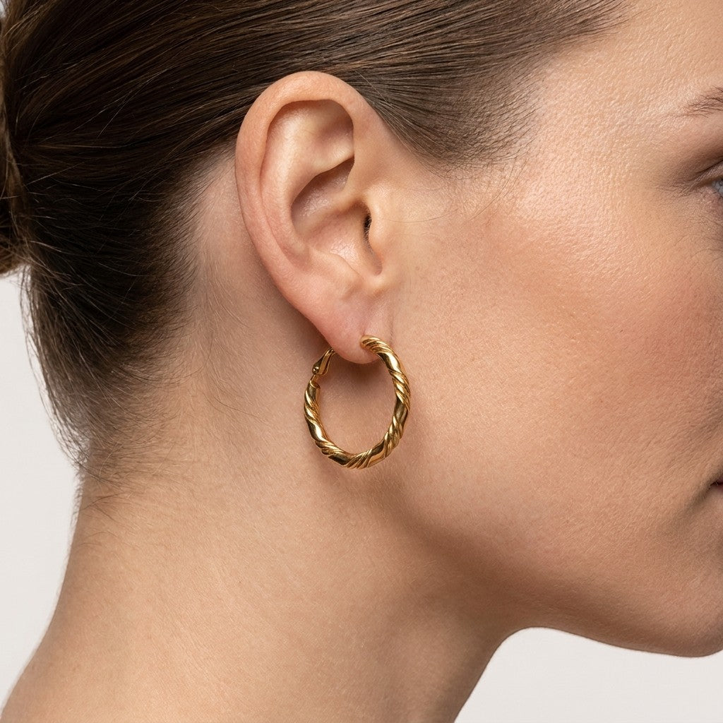 Aramat Jewels gold-coloured stainless steel hoop earrings with a twisted rope design, 25x3.5mm.