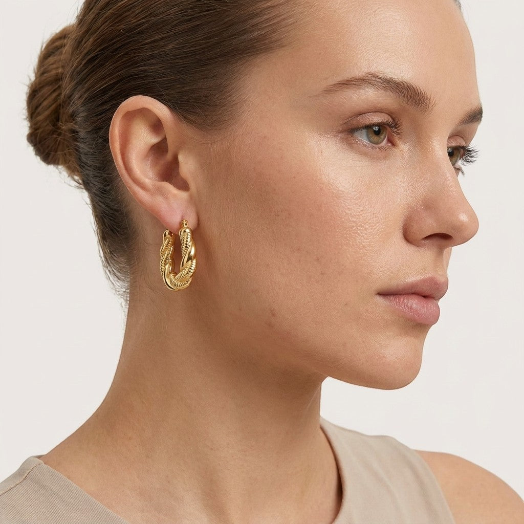 Aramat Jewels gold-tone twisted rectangular hoop earrings, 26x20mm, stainless steel, worn by a model.