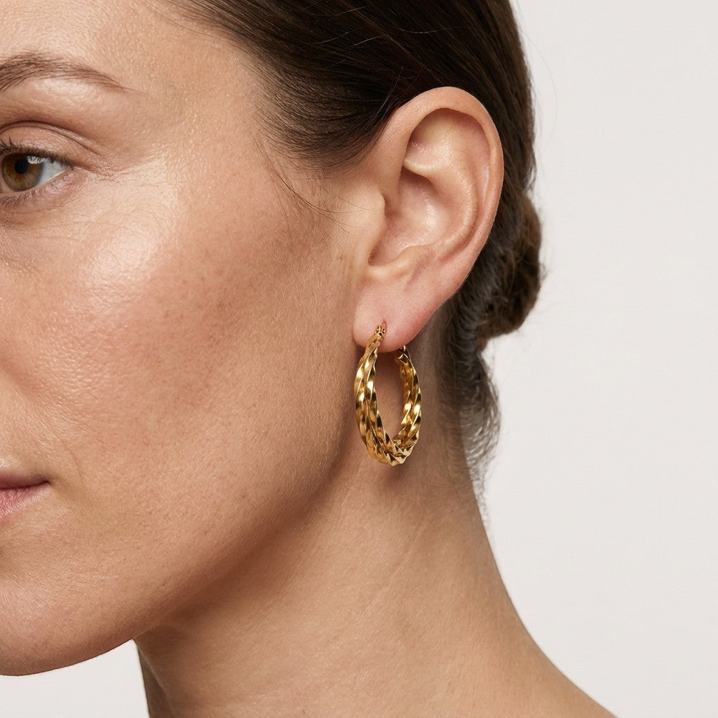 Aramat Jewels gold-tone twisted triple hoop earrings, 25mm or 30mm, made of stainless steel with gold plating.