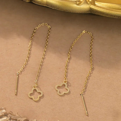 Aramat Jewels goudkleurige doortrek oorbellen van RVS met een elegante open bloemhanger aan een fijn kettinkje.