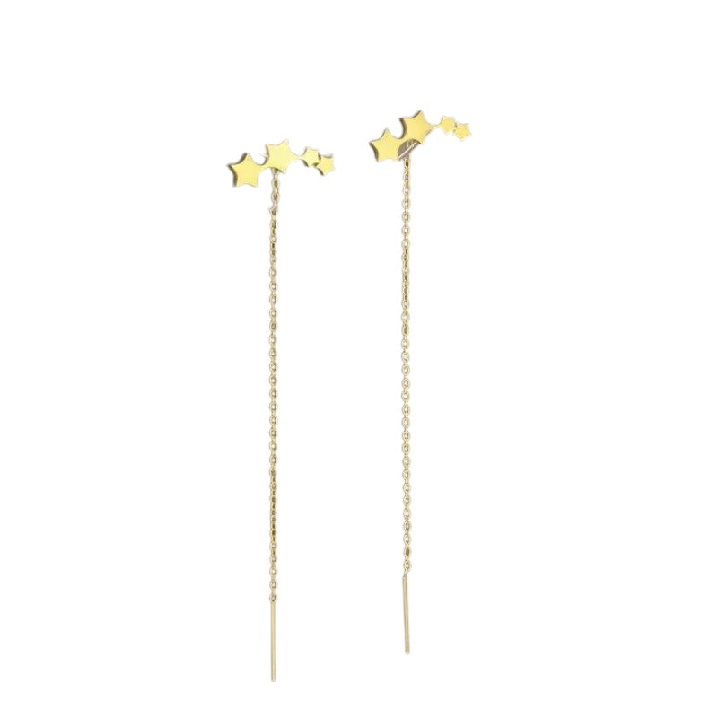 Aramat Jewels goudkleurige doortrek oorbellen van RVS met een speels sterretjesmotief en een lengte van 8 cm.