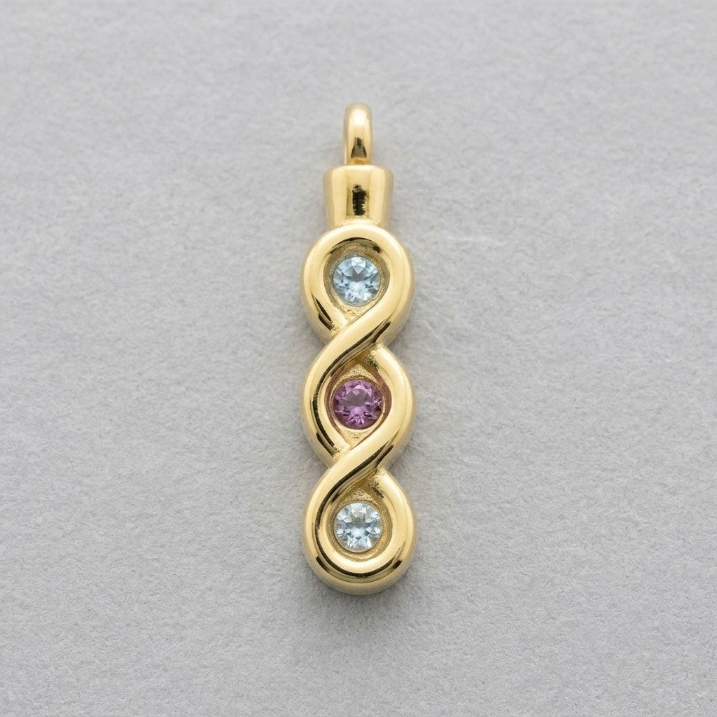 Aramat Jewels® goudkleurige stalen ashanger met infinity design en drie zirkonia's: twee lichtblauw en één roze.
