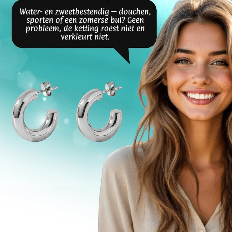 Aramat Jewels massieve zilverkleurige halve oorringen van glad RVS, 25x8mm, voor een moderne look.
