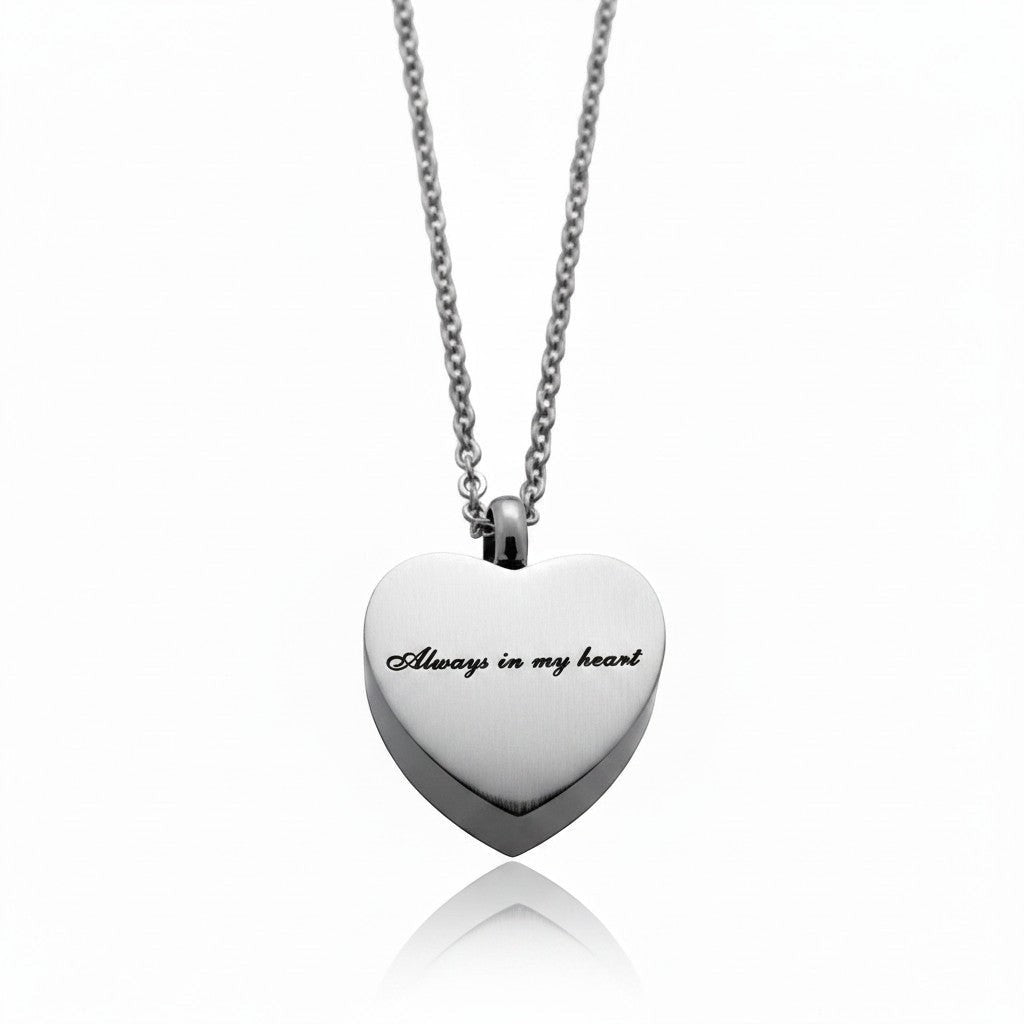 Aramat Jewels silver-tone stainless steel heart-shaped cremation pendant with "Always in my heart" engraving, on a 50cm chain.