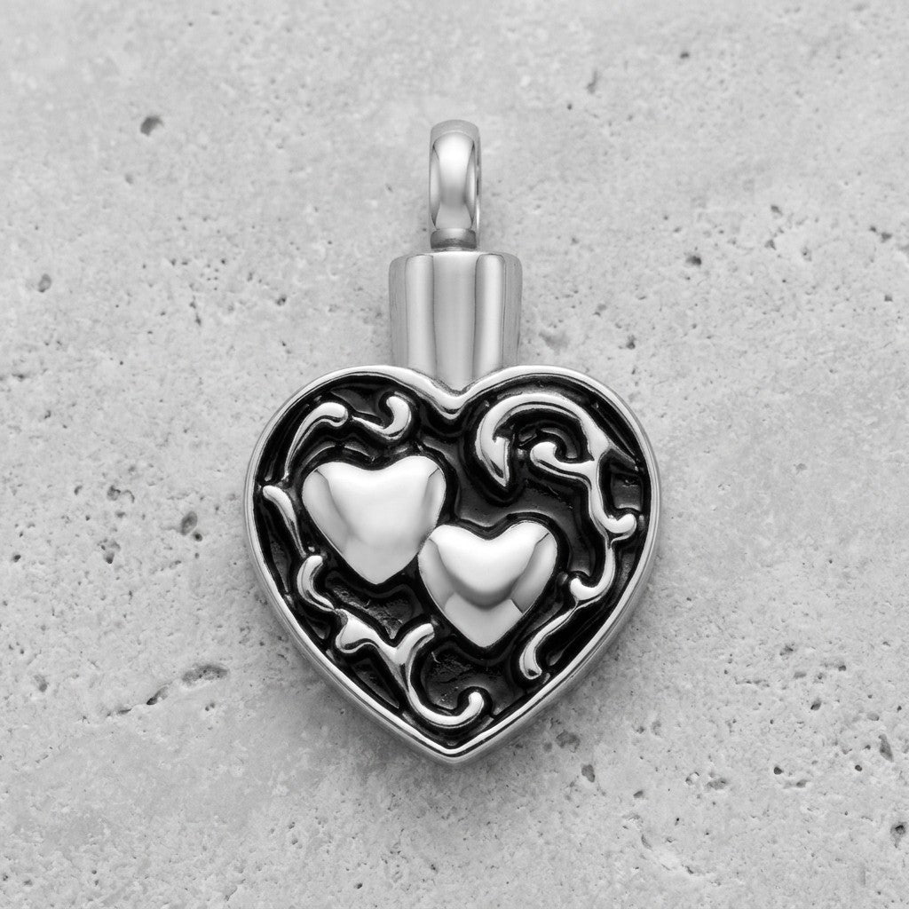 Aramat Jewels silver and black enamel heart cremation pendant with two hearts, 30x18mm, stainless steel.
