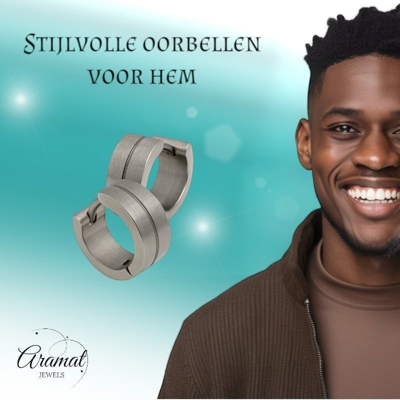 Aramat Jewels matte silver stainless steel hoop earrings with a subtle shine stripe, 13mm. Model wears a brown jacket.