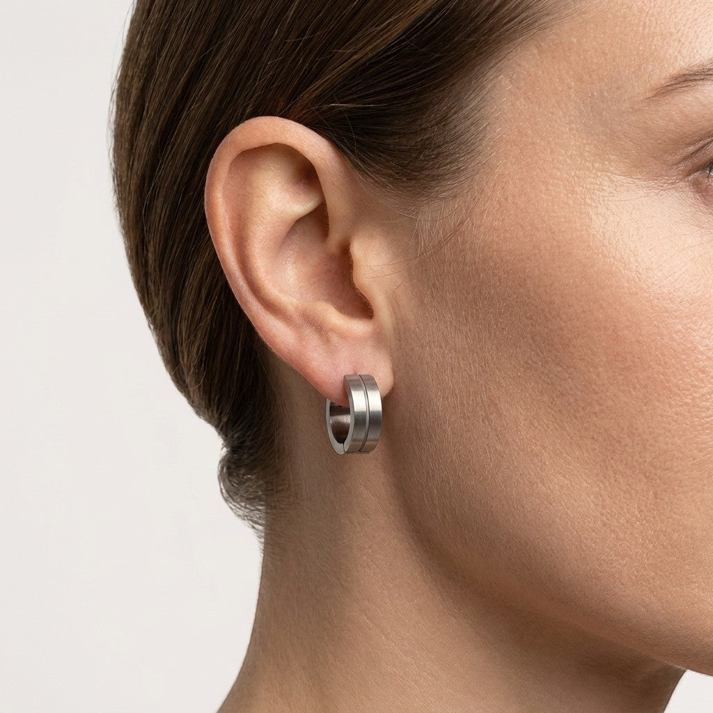 Aramat Jewels matte silver-tone stainless steel hoop earrings with a subtle glossy stripe detail, 13mm.