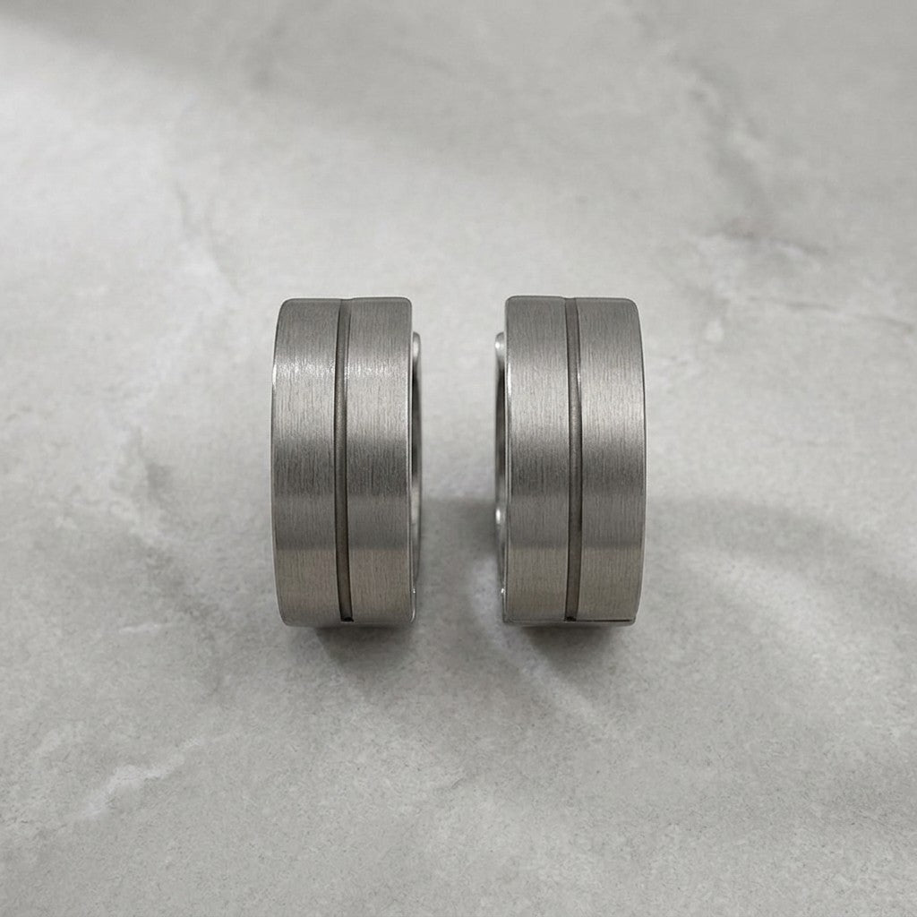 Aramat Jewels matte silver-tone stainless steel hoop earrings with a subtle glossy stripe detail, 13mm.