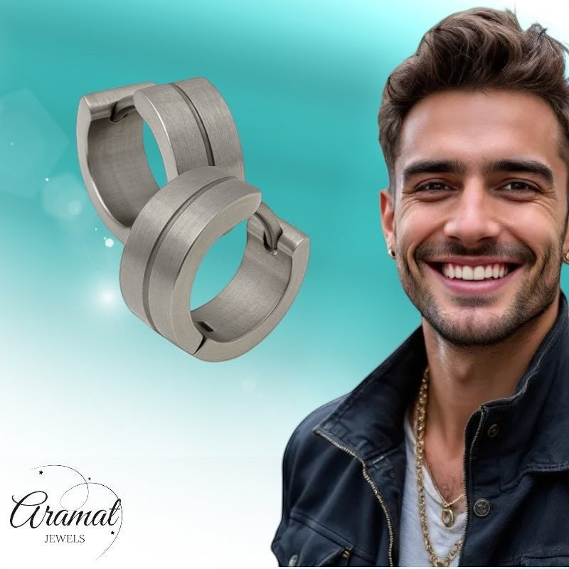 Aramat Jewels matte silver stainless steel hoop earrings with a glossy stripe detail, worn by a smiling man.