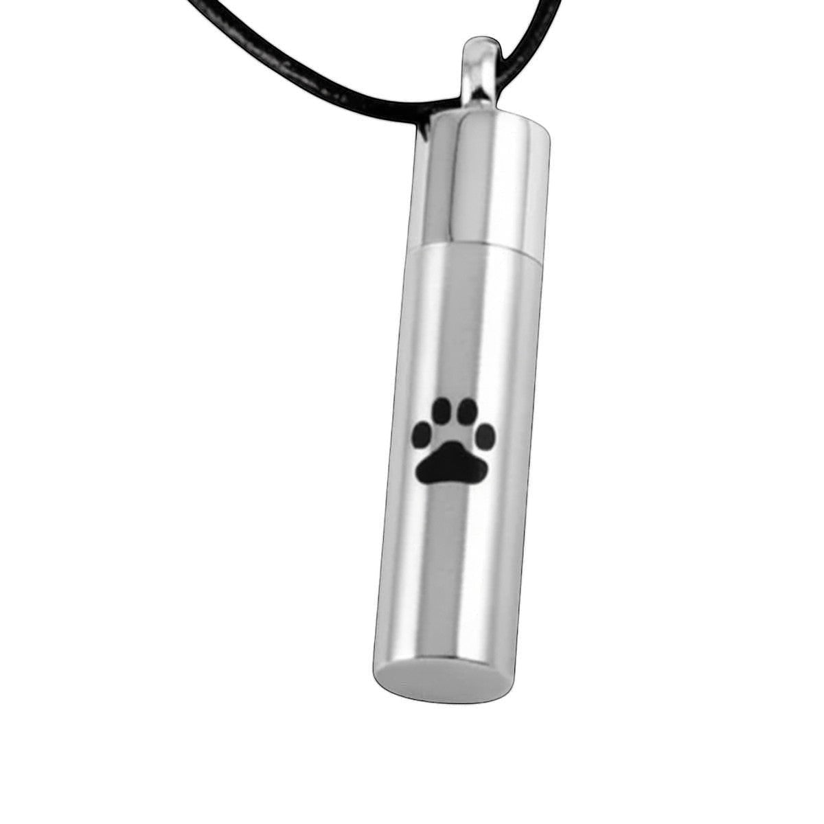 Aramat Jewels matte silver stainless steel cremation urn pendant with black paw print detail, 46mm tube shape.