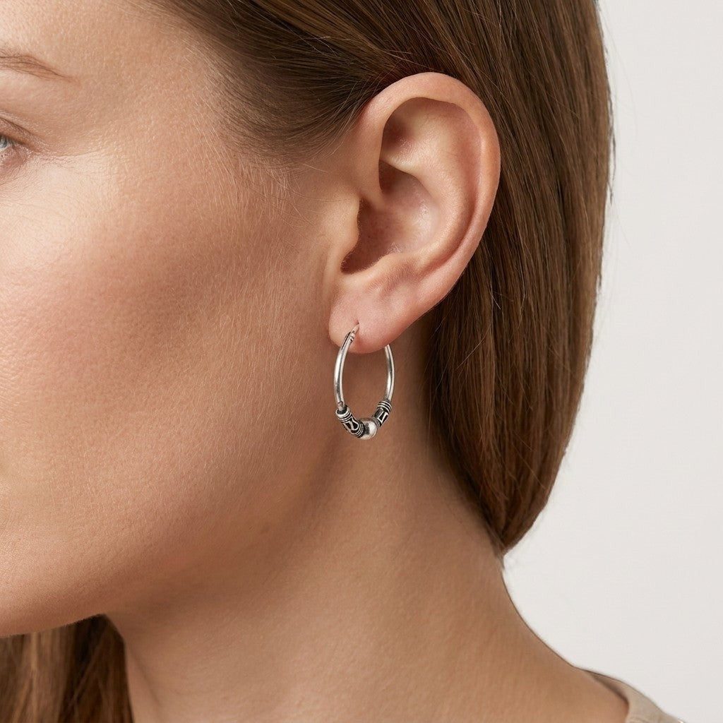 Aramat Jewels 18mm oxidised silver Bali hoop earrings with ethnic detailing.