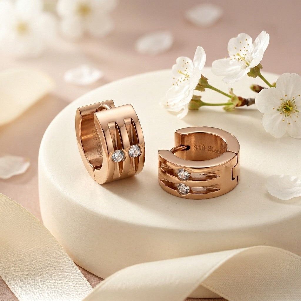 Aramat Jewels rose gold stainless steel huggie hoop earrings with two clear cubic zirconia stones each, 13mm diameter.