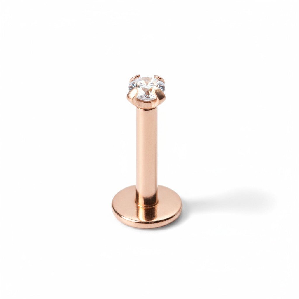 Aramat Jewels rose gold tragus and helix piercing made of 316L surgical steel with a 2mm clear zirconia stone.