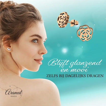 Aramat Jewels rose-shaped stainless steel stud earrings with an open design worn by a woman