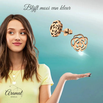 Aramat Jewels rose-shaped stud earrings in rose gold stainless steel with an openwork design, worn by a young woman.