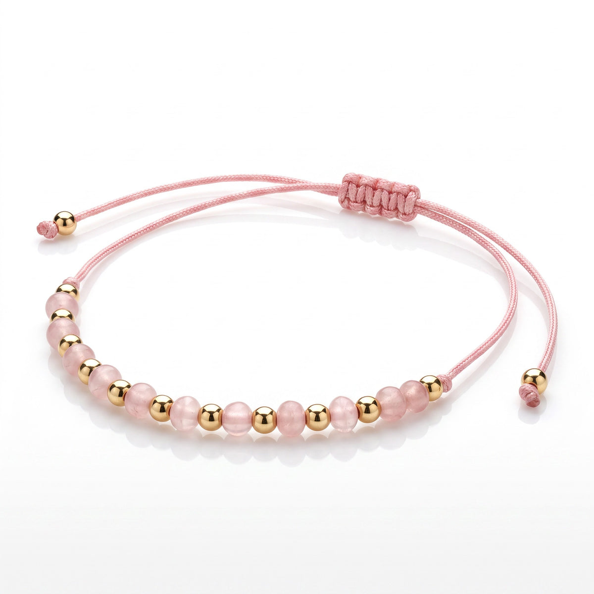 Aramat Jewels roze enkelbandje met 5mm cats eye kralen en goudkleurige accenten, verstelbaar met schuifknoop.