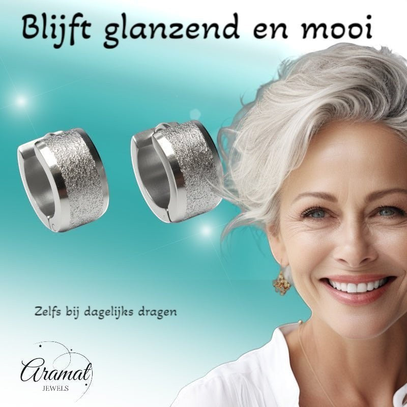 Aramat Jewels sandblasted silver-tone stainless steel huggie hoop earrings, 13mm, with a matte textured finish and a smooth inner band.