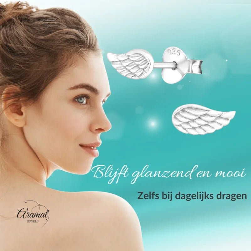 Aramat Jewels 925 sterling silver angel wing stud earrings with engraved feather detail on a woman