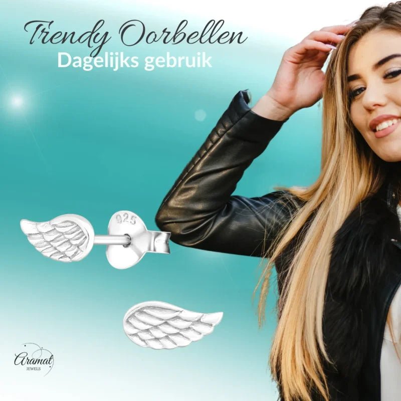 Aramat Jewels 925 sterling silver angel wing stud earrings with detailed engraved feather relief on a model