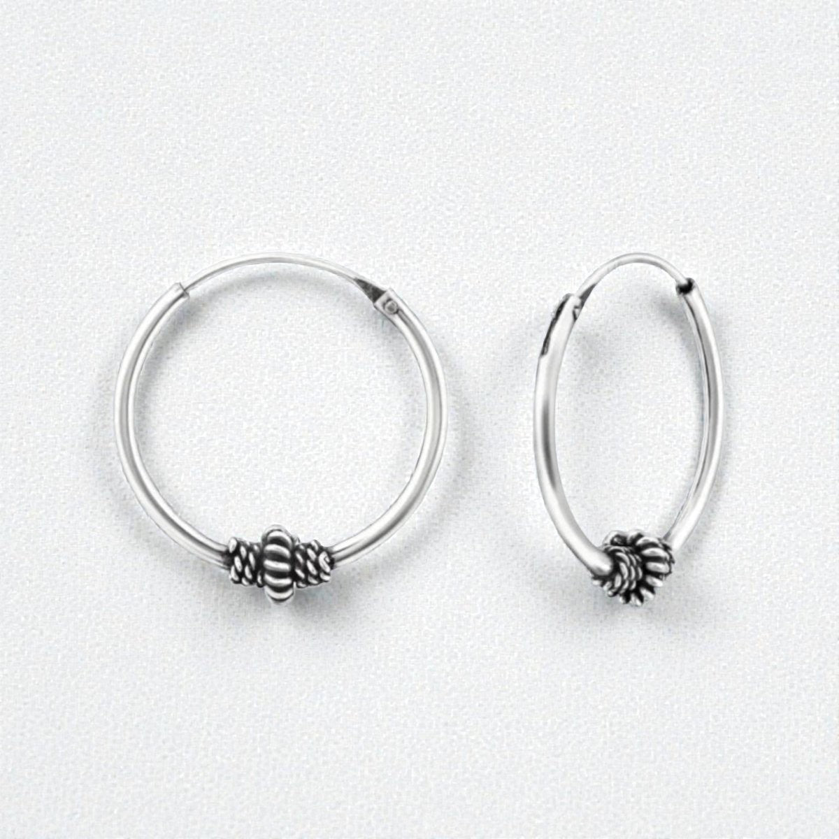Aramat Jewels 18mm silver Bali hoop earrings with intricate ethnic design and oxidized finish.
