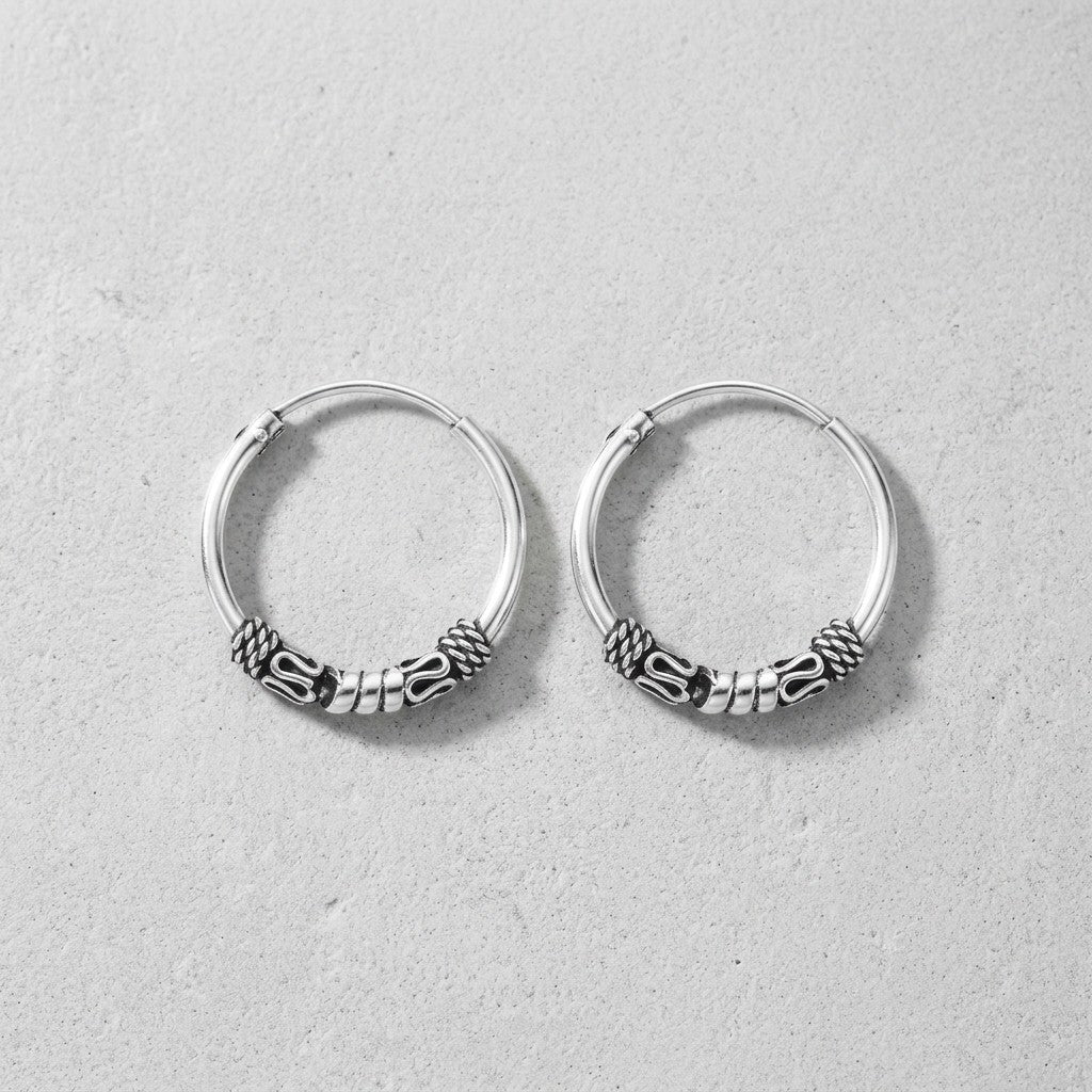 Aramat Jewels thin 16mm silver Bali hoop earrings with intricate tribal-inspired detailing, perfect for boho style.
