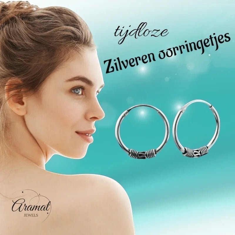 Aramat Jewels unisex 16mm silver Bali hoop earrings with tribal detailing. Model's shoulder and neck visible.