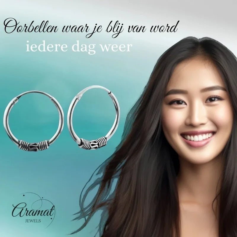 Aramat Jewels unisex 16mm silver Bali hoop earrings with intricate detailing, worn by a smiling young woman.