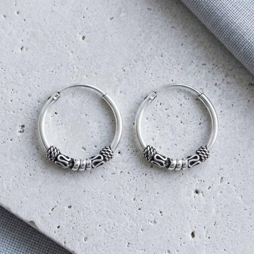 Aramat Jewels unisex silver Bali hoop earrings, 16mm diameter, with intricate braided and cylindrical bead details.