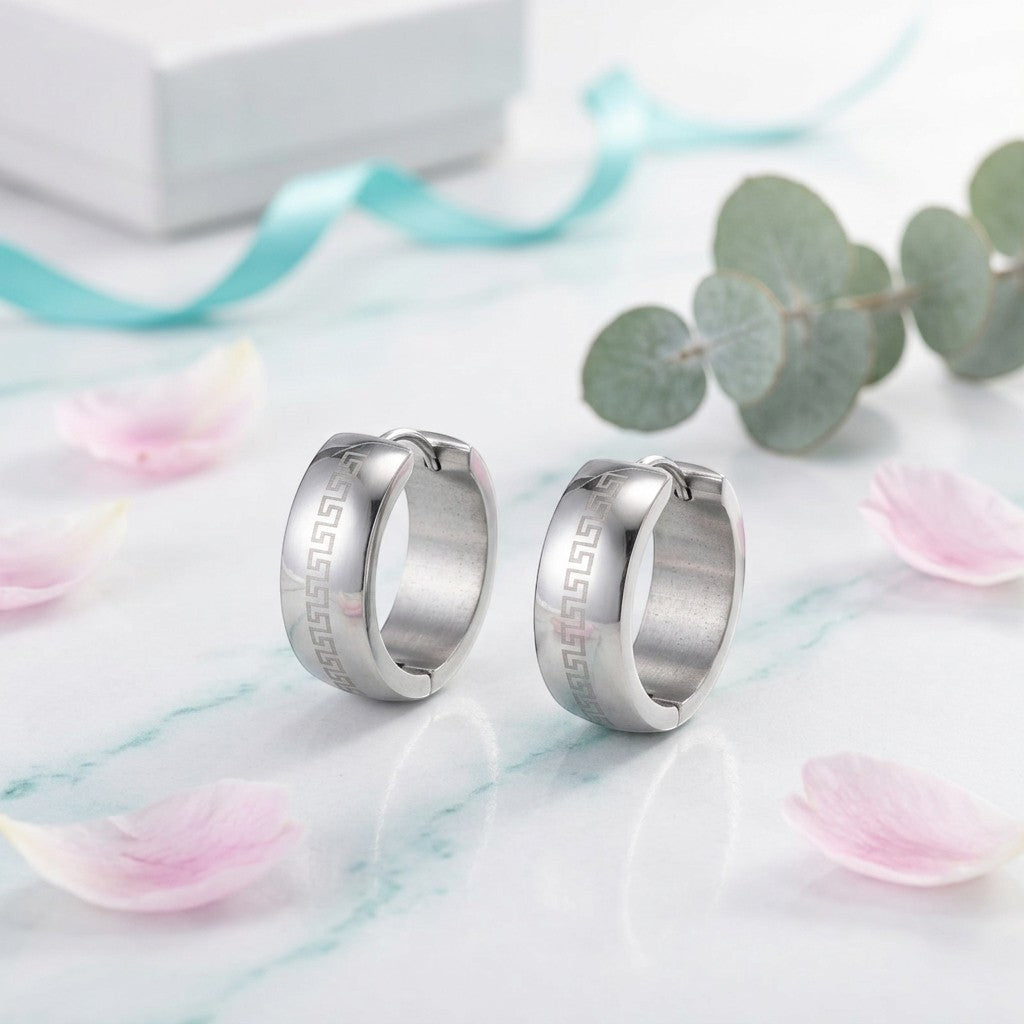 Aramat Jewels silver stainless steel hoop earrings with Greek key pattern, 13mm diameter, 7mm width.