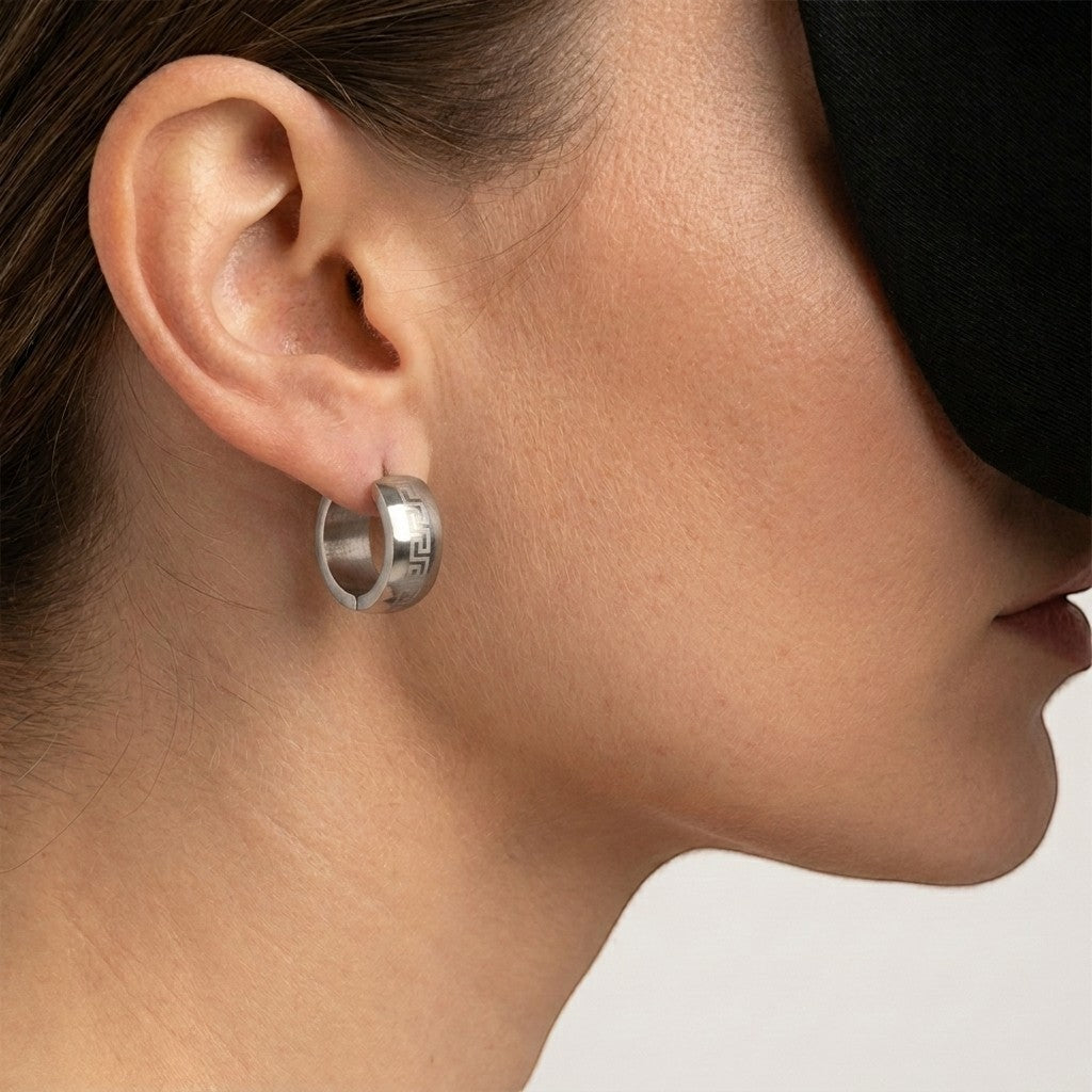 Aramat Jewels silver stainless steel hoop earrings with Greek key pattern, 13mm diameter, 7mm width.