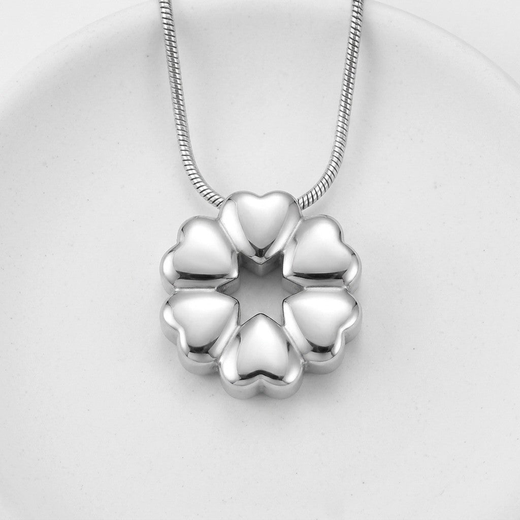 Aramat Jewels silver stainless steel circular cremation pendant with heart shapes, 20x20mm, water-resistant.